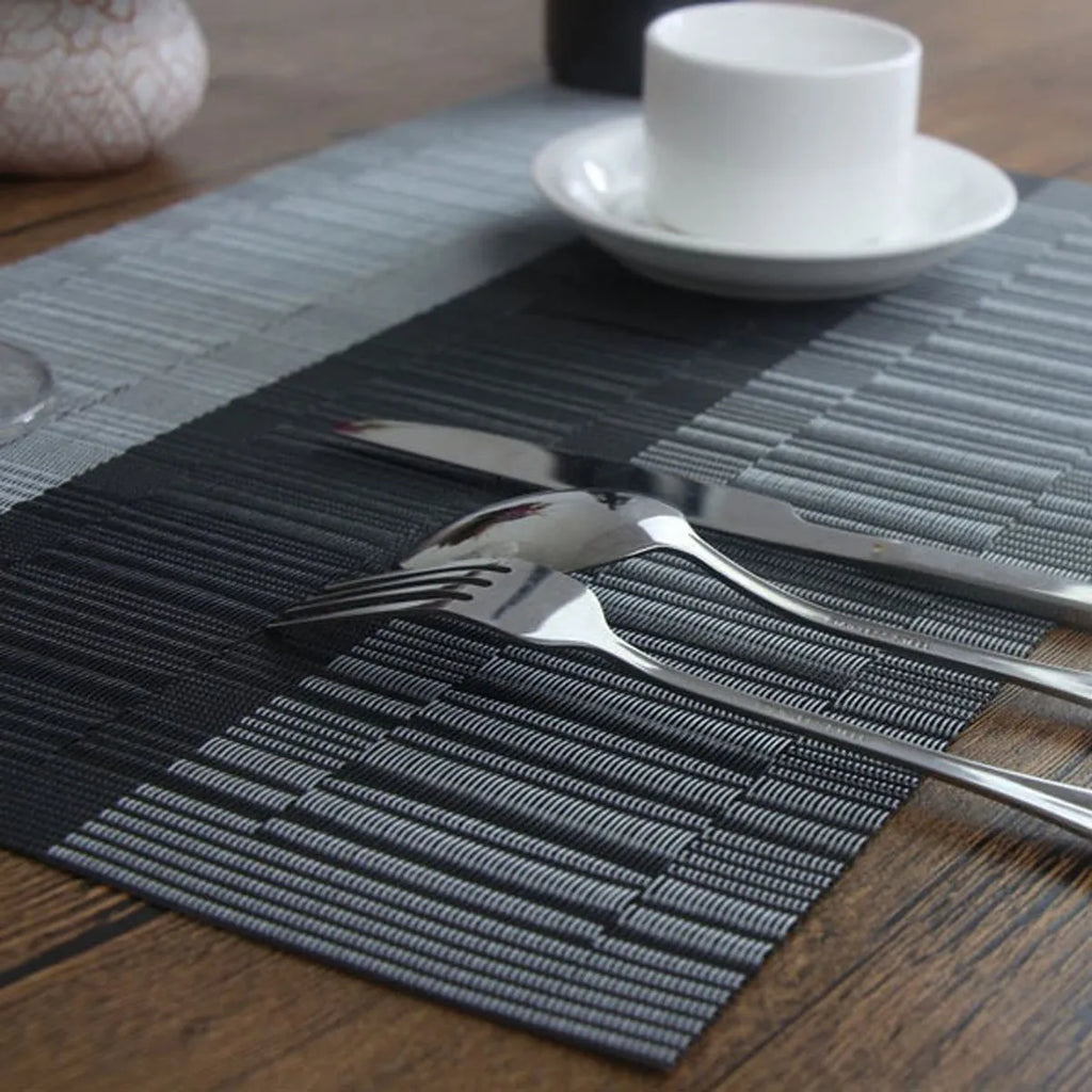 PVC non-slip dish mat in gradient bamboo black colour on a kitchen countertop.