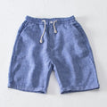 Men's high-waist loose tapered linen trousers in dark gray, front view, with relaxed fit and tapered leg