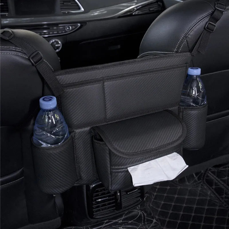 Black leather car seat hanging storage organiser for tissue boxes, shown between vehicle front seats.