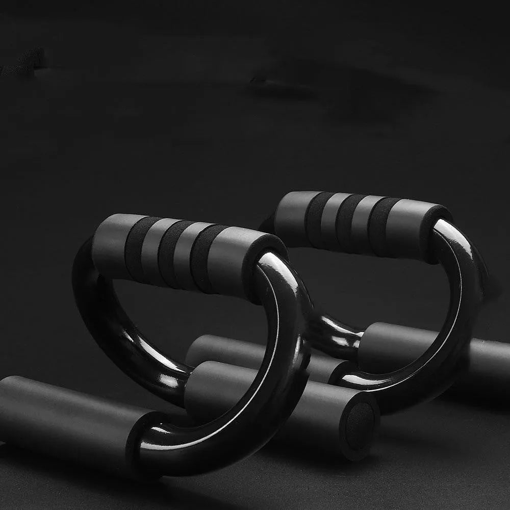 Black S shape push-up bracket rack on a home gym floor