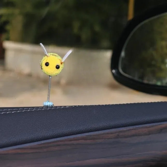 Swing Spring Bee soft fur ball car decoration with cartoon bee shape on adhesive backing.