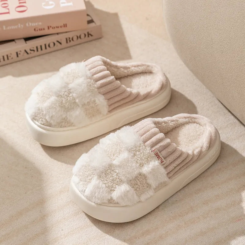 Plaid pattern women's slippers with plush lining and a light-coloured non-slip PVC sole, shown in a grey colour option.