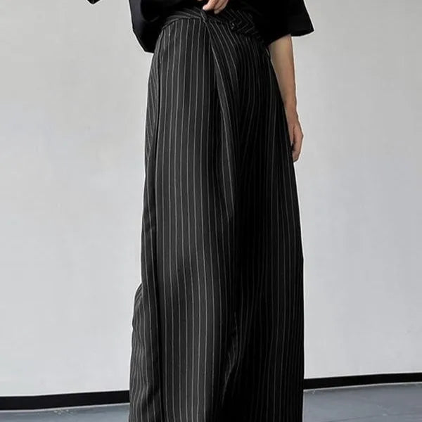 Men's black vertical striped pleated casual trousers showing elastic construction detail