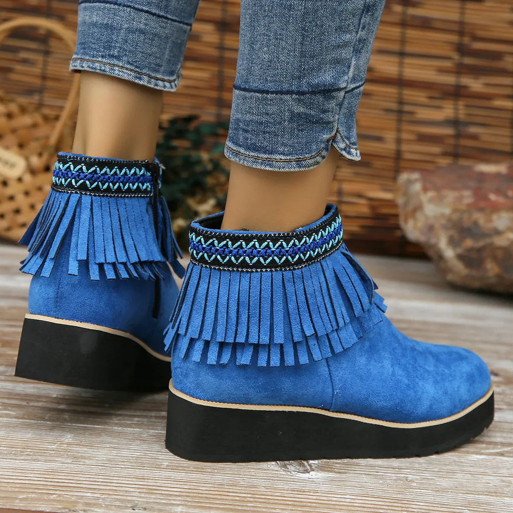 Women's dark brown suede wedge ankle boots with side zip and tassel detail on a thick rubber sole.
