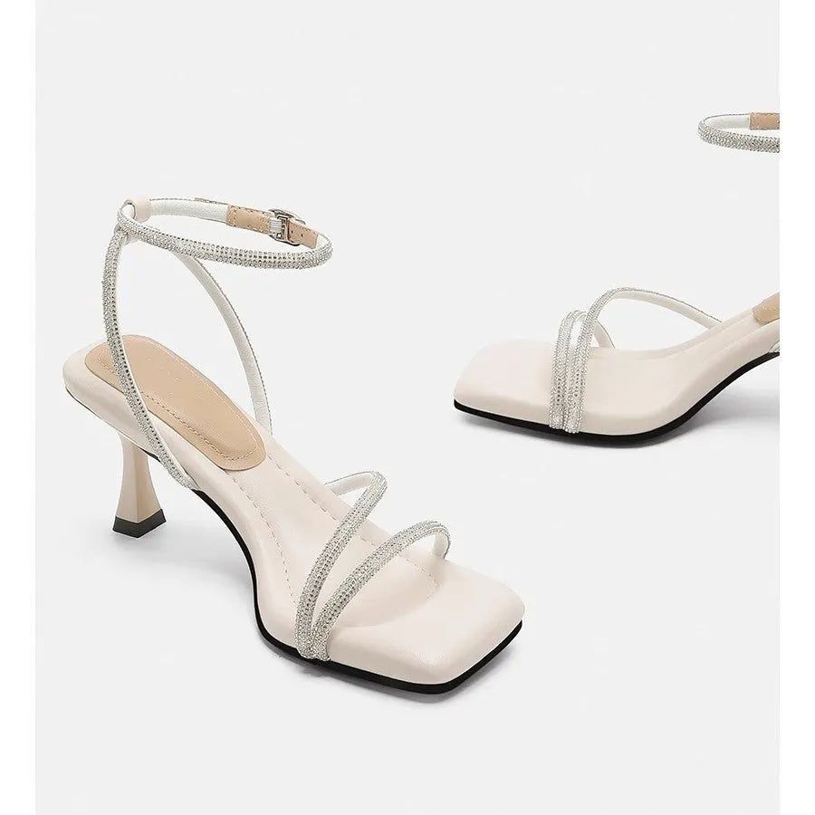 Women's silver rhinestone ankle-strap sandals with a square toe and buckle fastening.