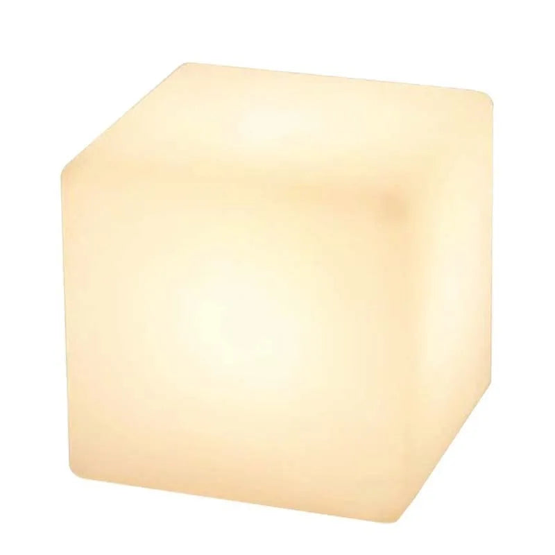 White square LED cube stool light on patio, modern outdoor seating with integrated lighting.