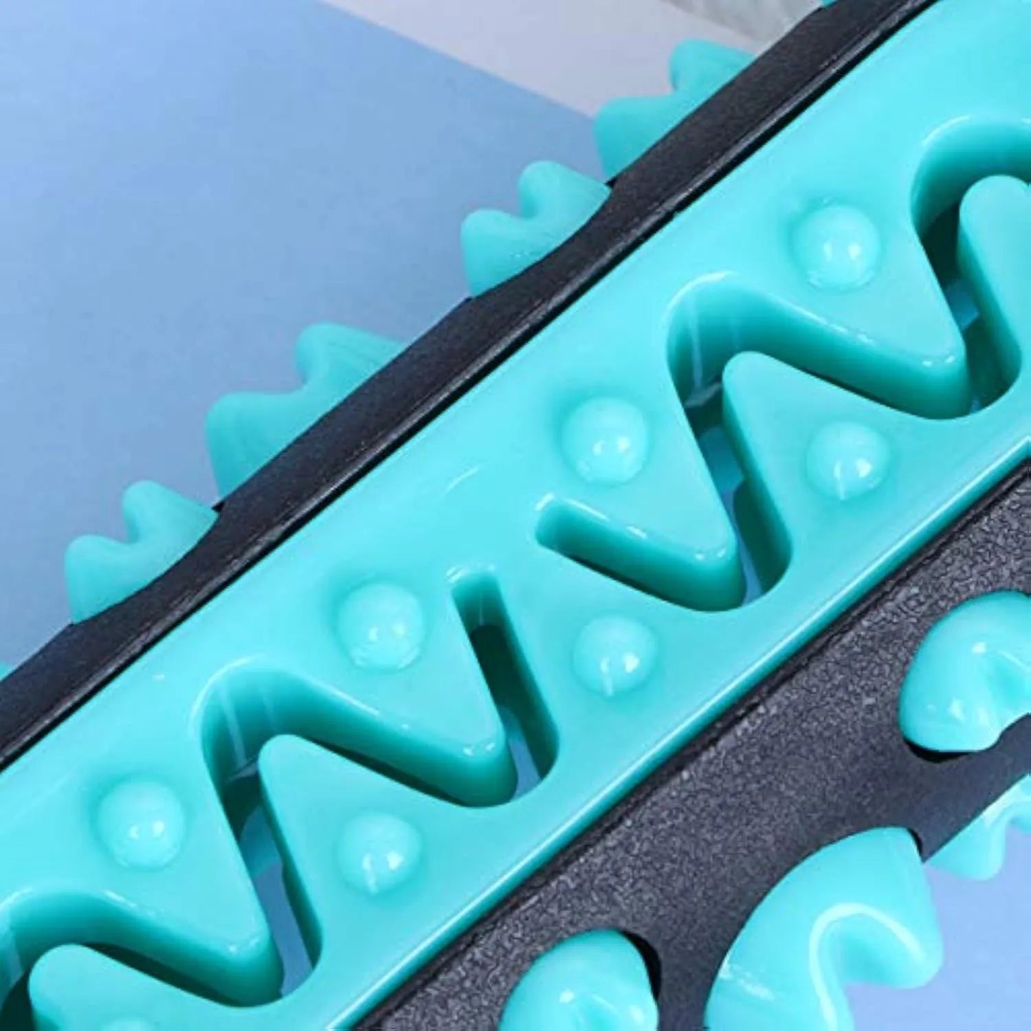 A natural rubber dog toothbrush chew toy in blue, showing its textured surface for dental cleaning.