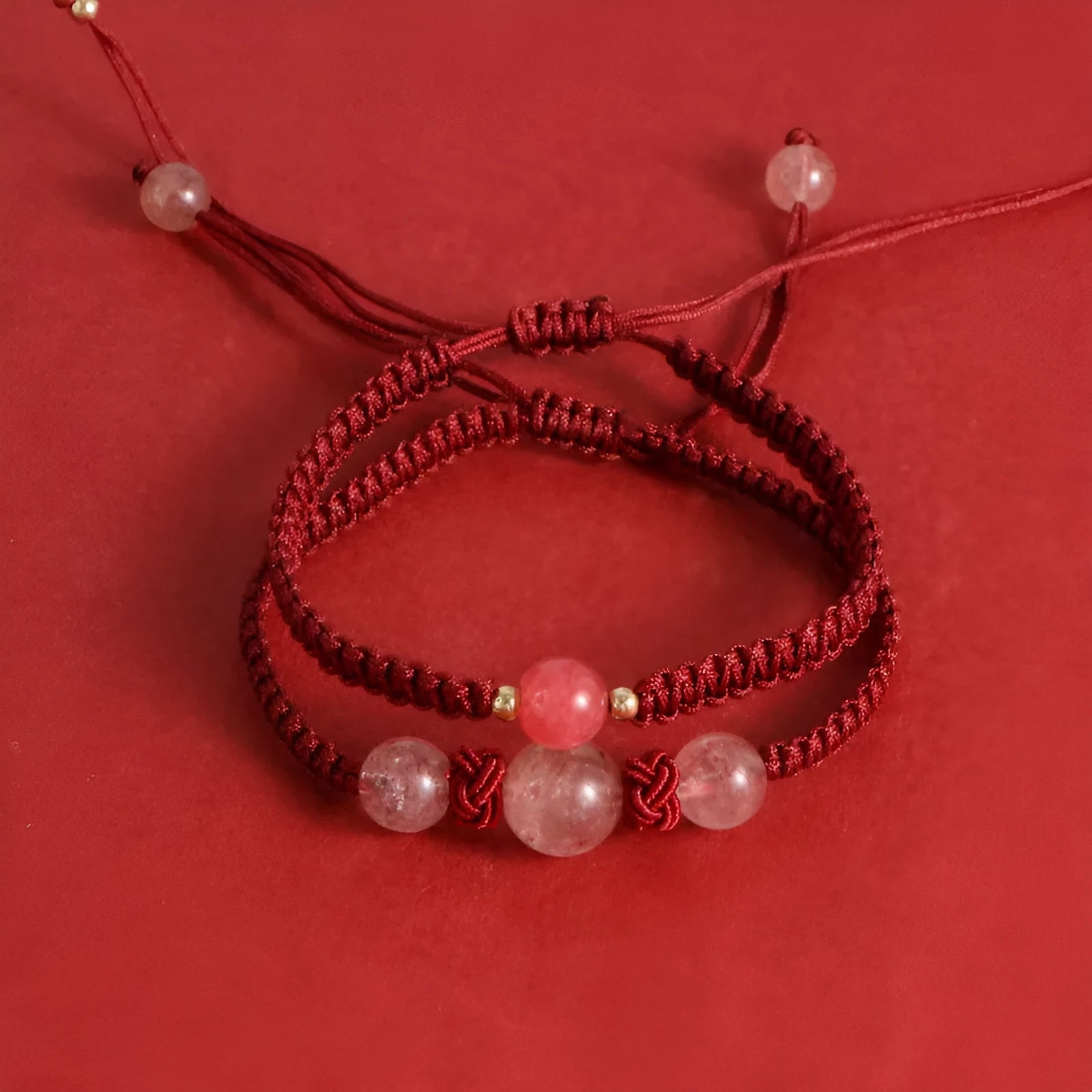 Woven red rope bracelet with natural strawberry quartz beads and alloy metal components