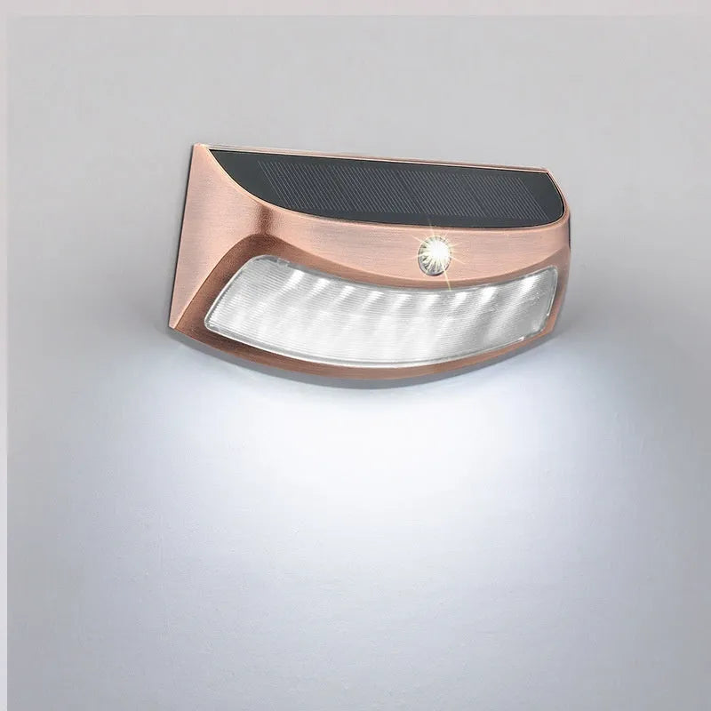 Solar outdoor wall lamp with smiling face design measuring 153mm wide