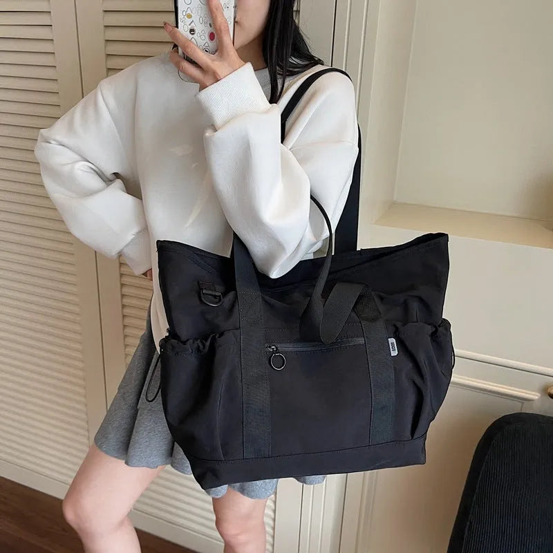 Women's lightweight oxford cloth travel bag in grey, black or green with 36-55L capacity