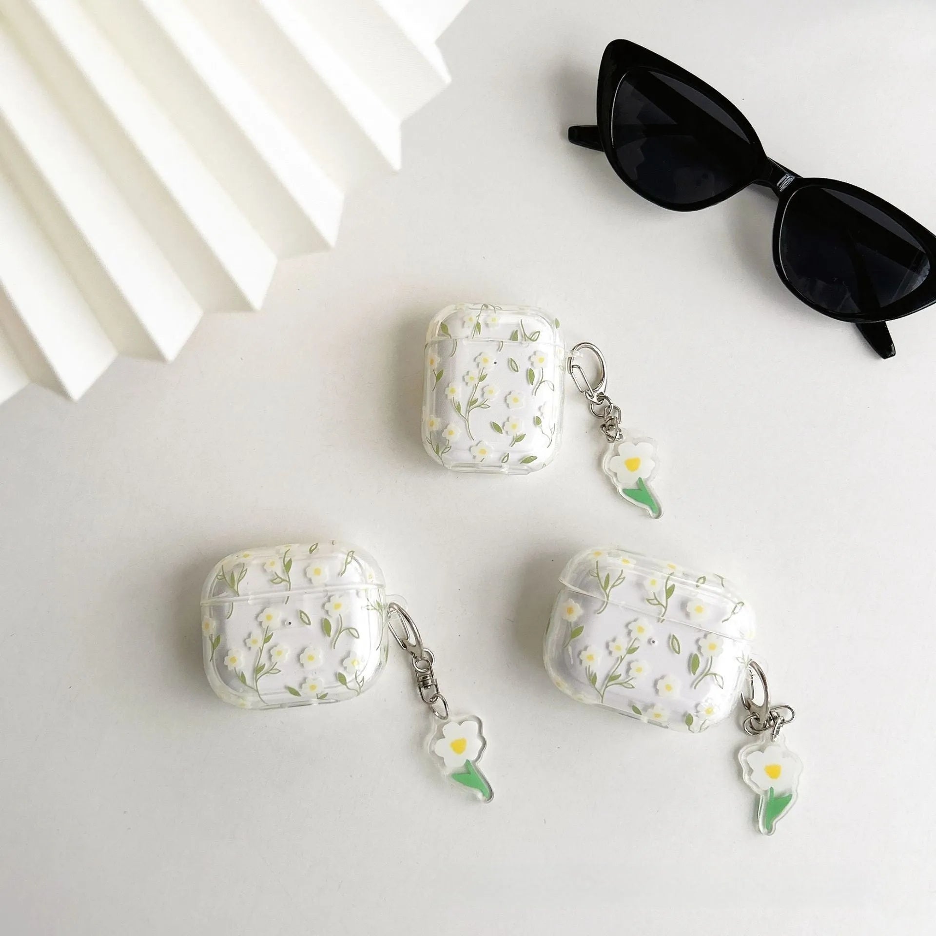 White floral high-transparency TPU protective cover for Apple AirPods showing decorative patterns