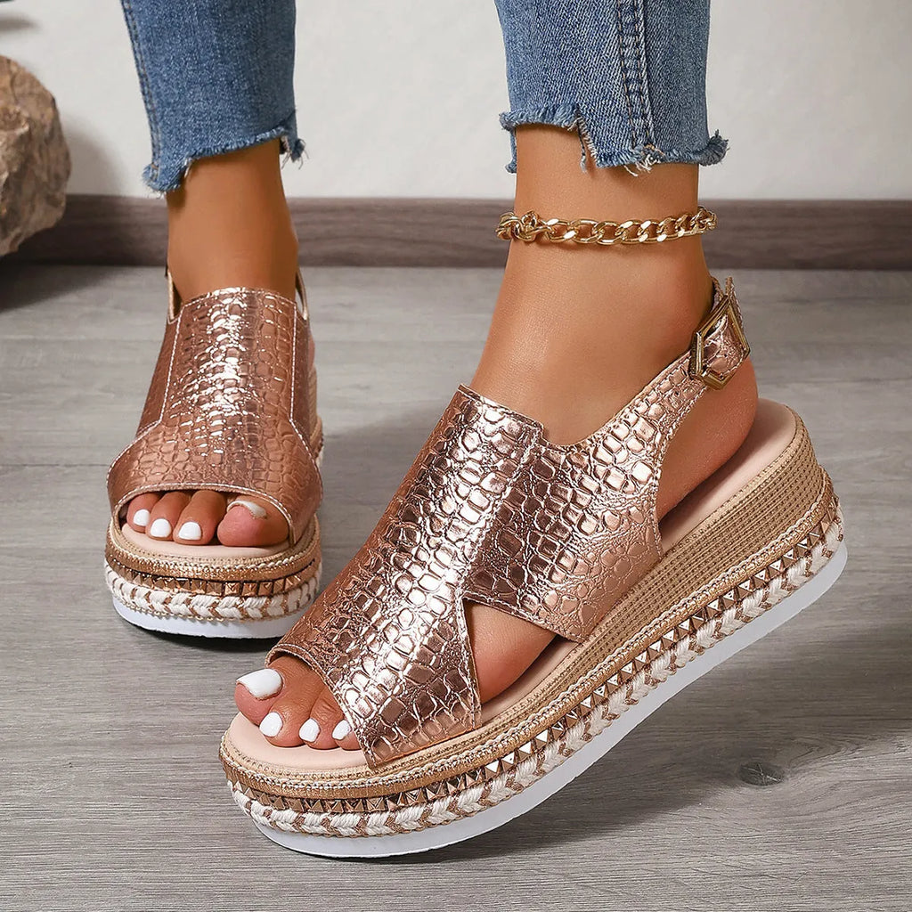 Gold women's Roman sandals with round toe, hollow-out upper, and an ankle buckle.