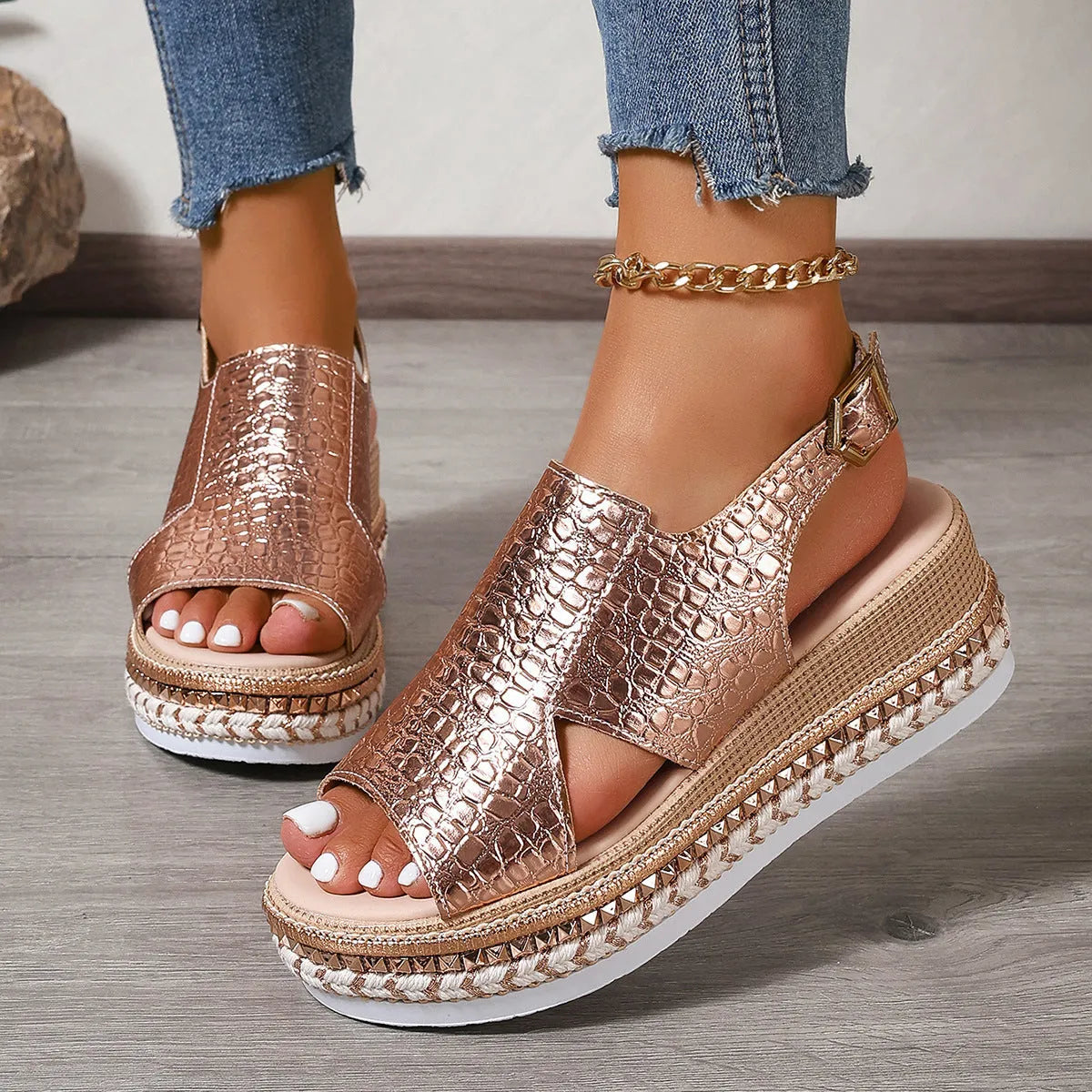 Gold women's Roman sandals with round toe, hollow-out upper, and an ankle buckle.