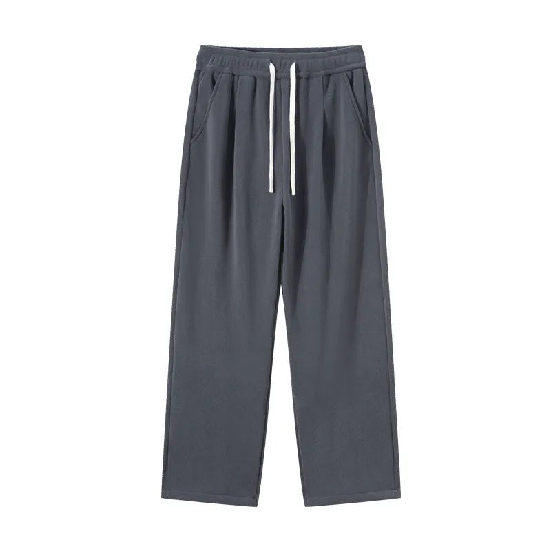 Man wearing apricot coloured double-sided polar fleece winter trousers with a loose fit and drawstring waist.