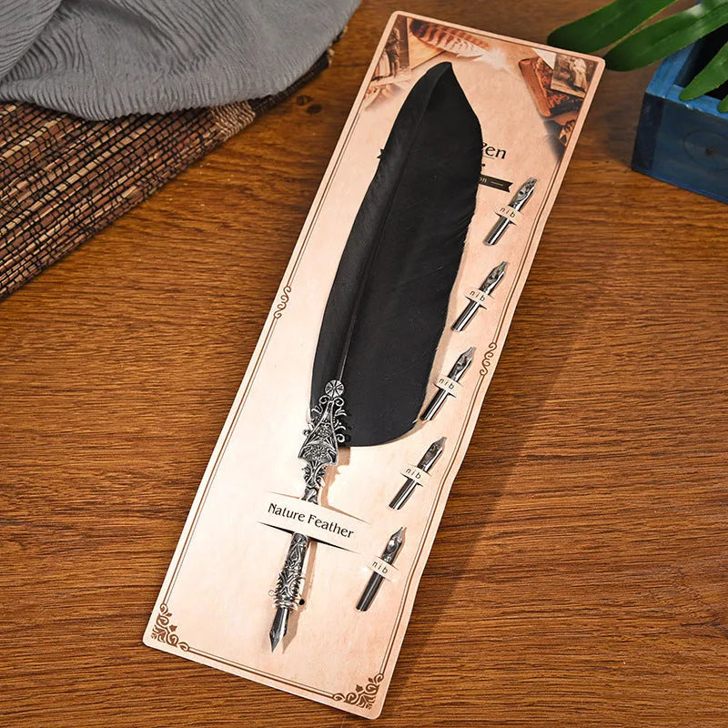 Retro zinc alloy feather dip pen in choice of ten colours on a desk.