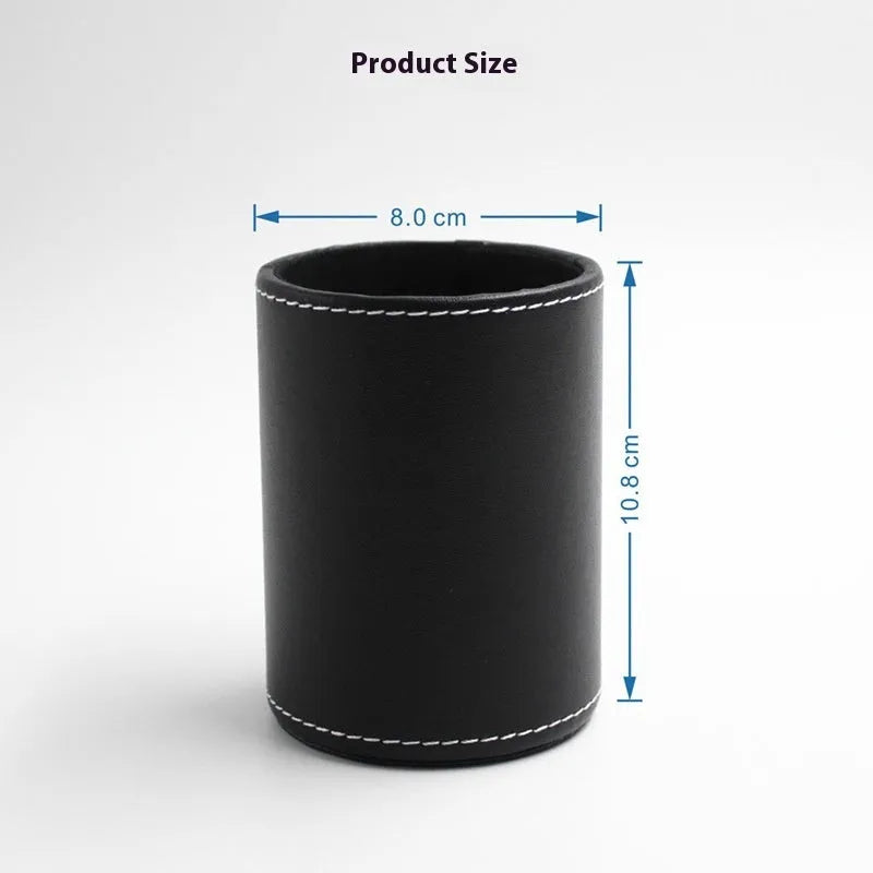 Small round black leather pen holder on a desk