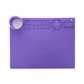 Light blue silicone painting mat measuring 50 by 40 centimetres with two round paint wells.