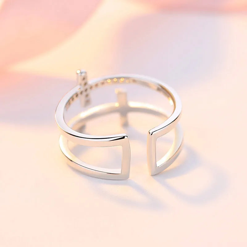 Women's adjustable copper ring featuring a miniature double cross design with sterling silver and zircon inlay.
