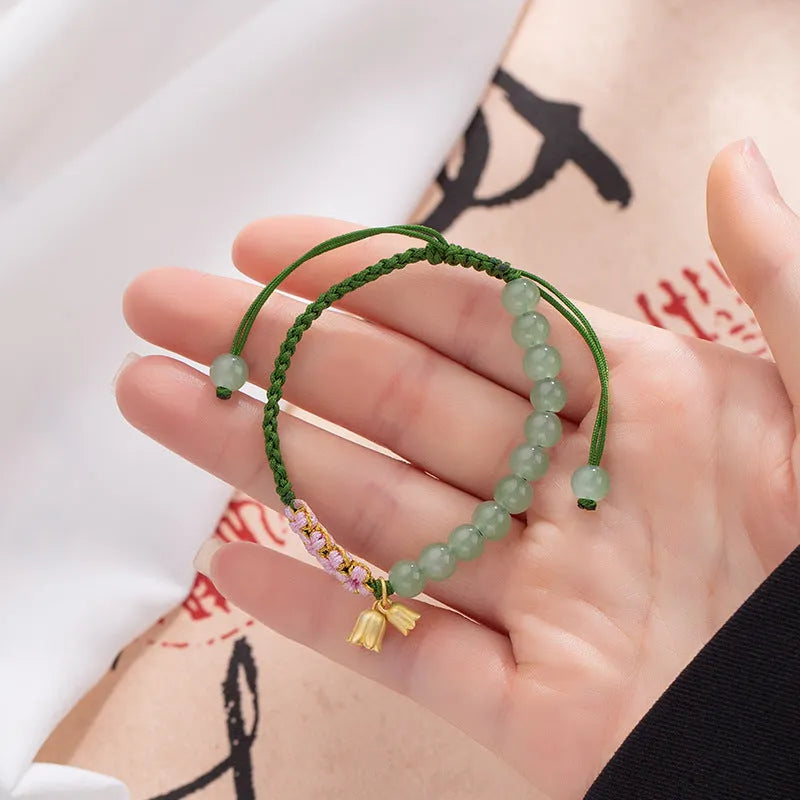 Red rope hand woven women's bracelet with floral design in Lily carrying strap colour