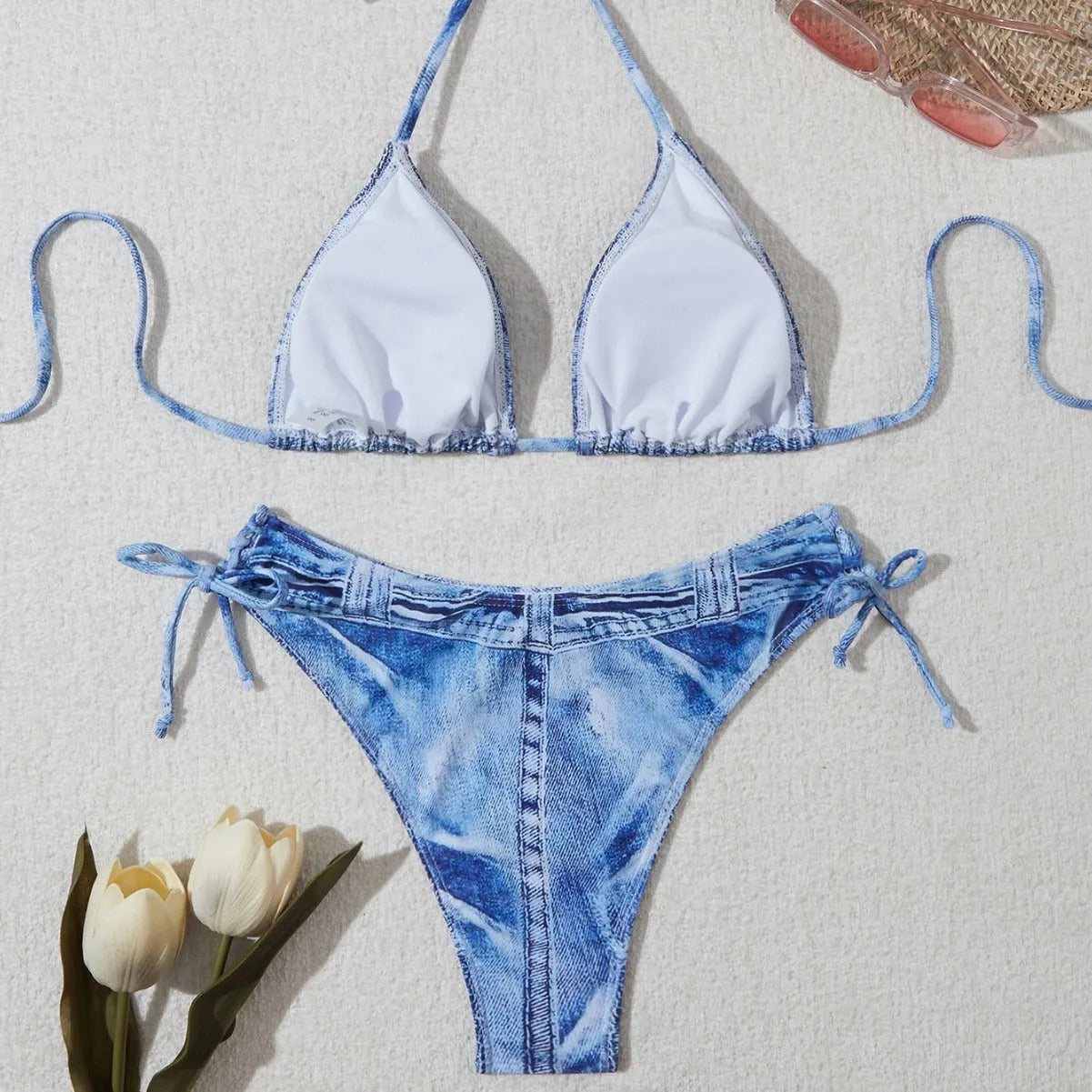 Denim blue printed women's bikini set with strap design, shown on a model.
