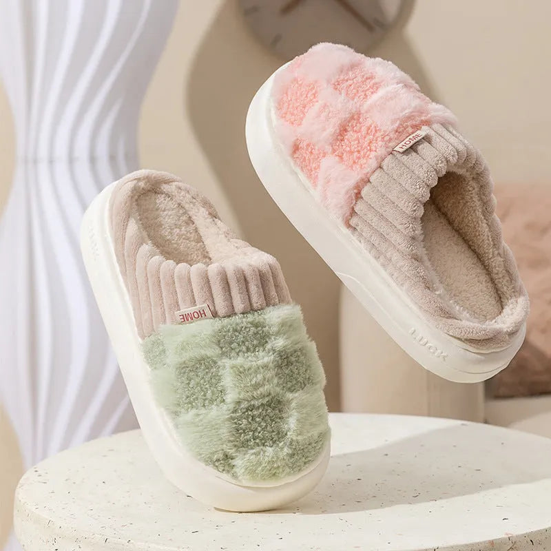 Plaid pattern women's slippers with plush lining and a light-coloured non-slip PVC sole, shown in a grey colour option.