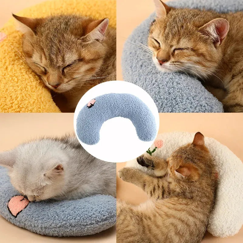 Blue U-shaped plush pet pillow for a small dog or cat, showing raised rim and quilted texture.