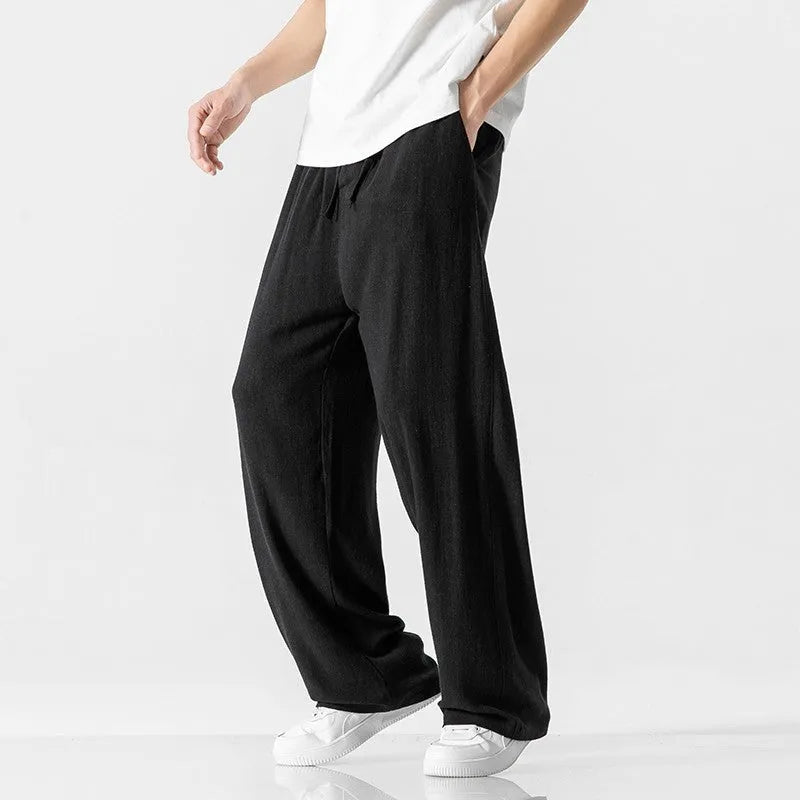 Men's beige bamboo fibre linen trousers with a straight leg, cropped length, and drawstring waist.