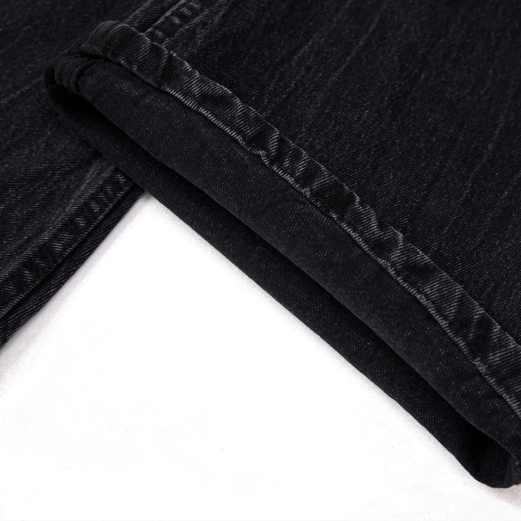 Men's black straight-leg jeans with a lightning crack wash pattern on cotton denim.