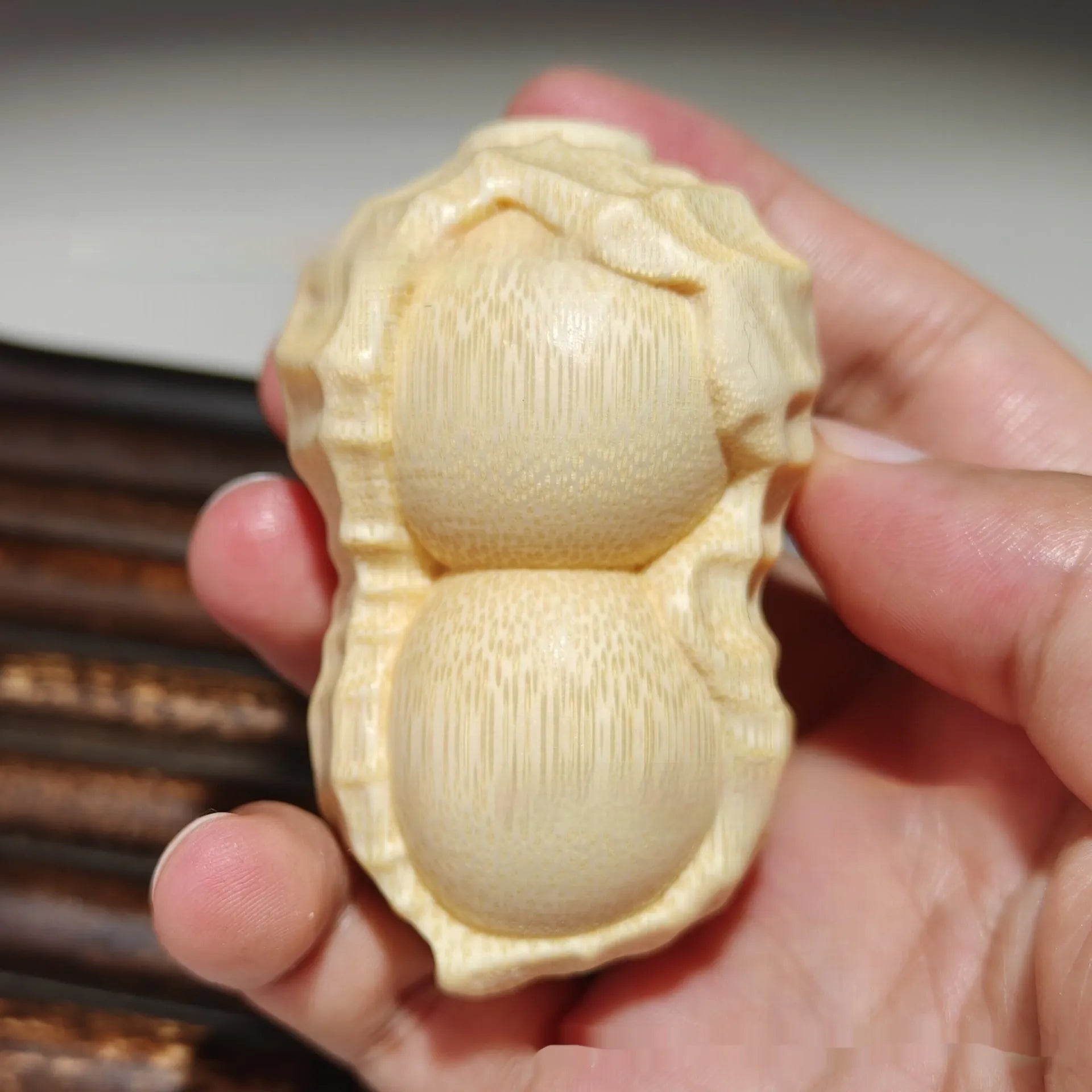 Modern simplicity style solid bamboo carving peanut ornament on a neutral background.