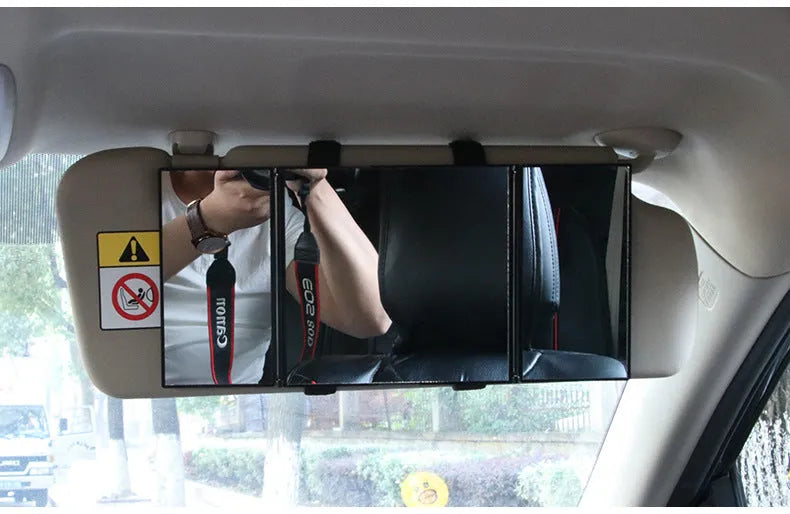 Silver portable folding car mirror shown both closed and open to double its length.