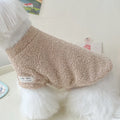 Reversible brown cloud velvet dog jacket shown on a small dog, illustrating the fluffy texture and fit.