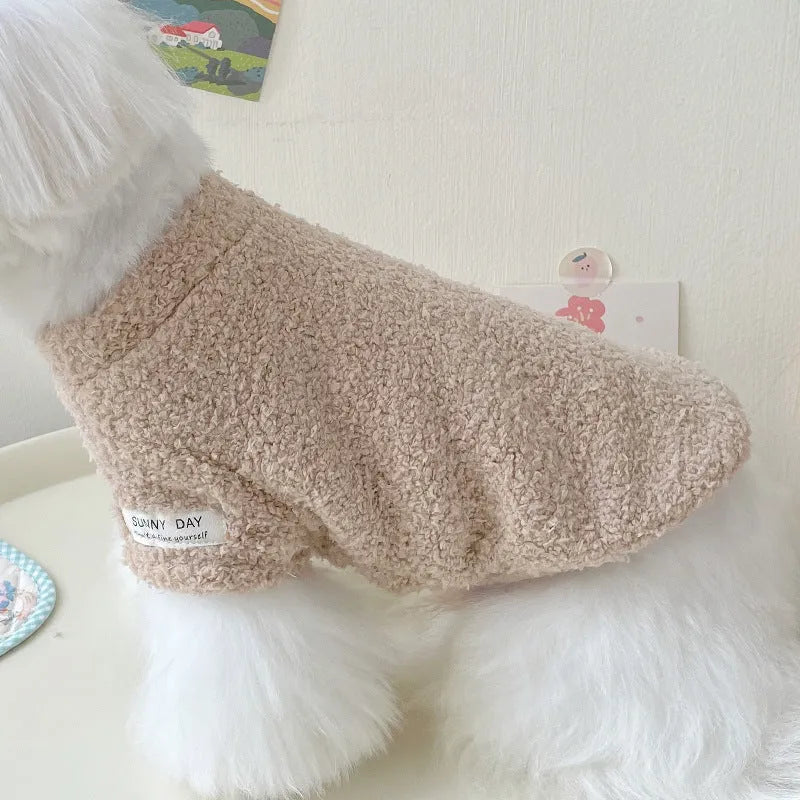 Reversible brown cloud velvet dog jacket shown on a small dog, illustrating the fluffy texture and fit.