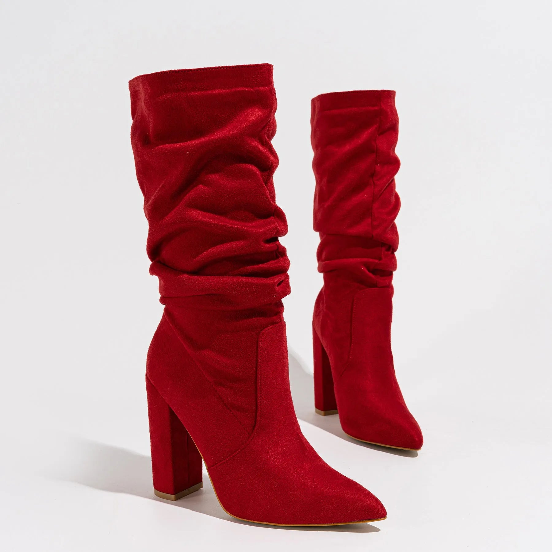 Black suede women's boots with a chunky high heel and pointed toe, shown on a mid-calf length.