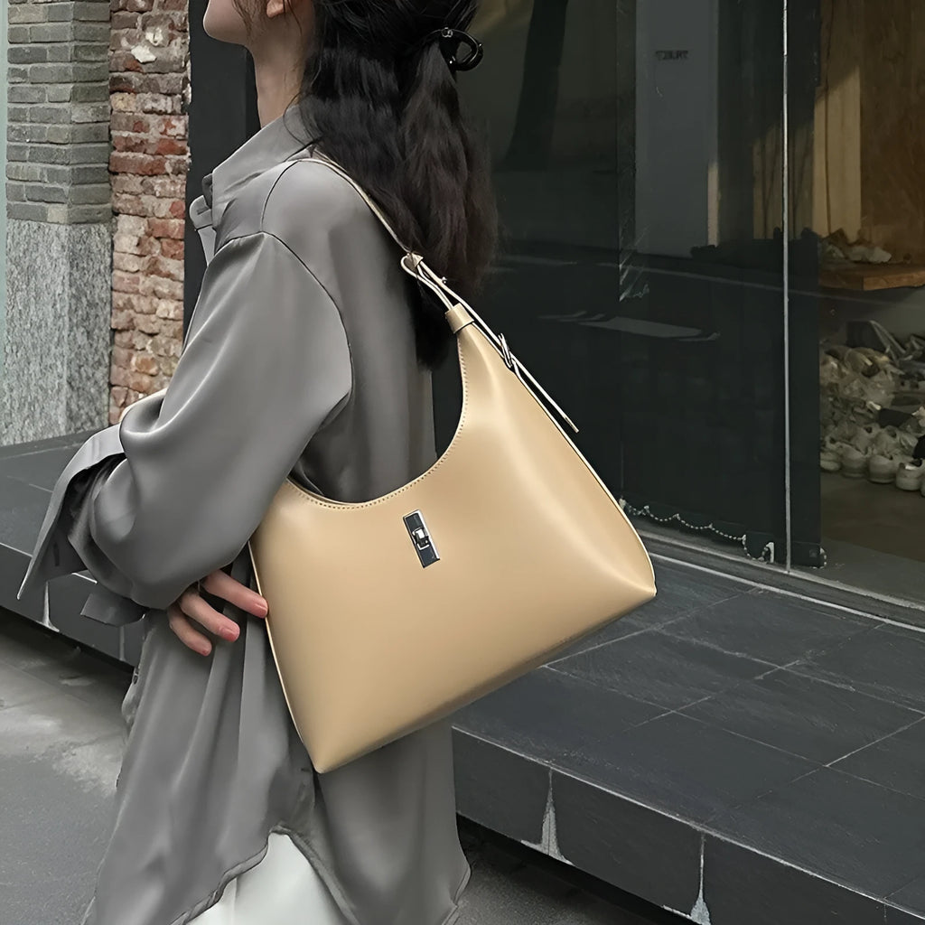 Genuine leather dumpling-shaped crossbody shoulder bag in apricot colour with street-trend details.