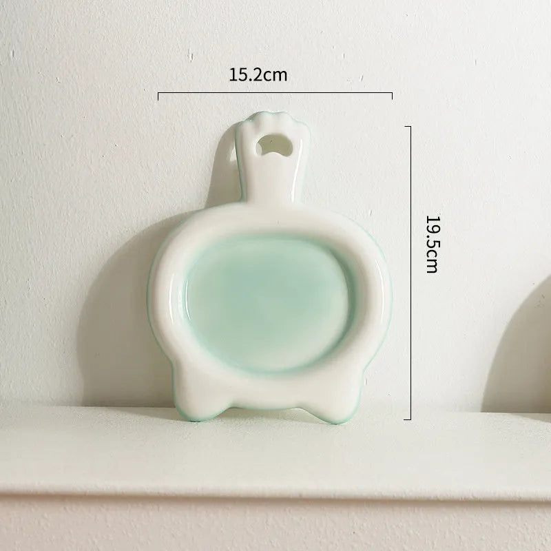 Ceramic cat bowl in blue, green, pink, or yellow colour options, shown in large and small sizes with shallow mouth design.