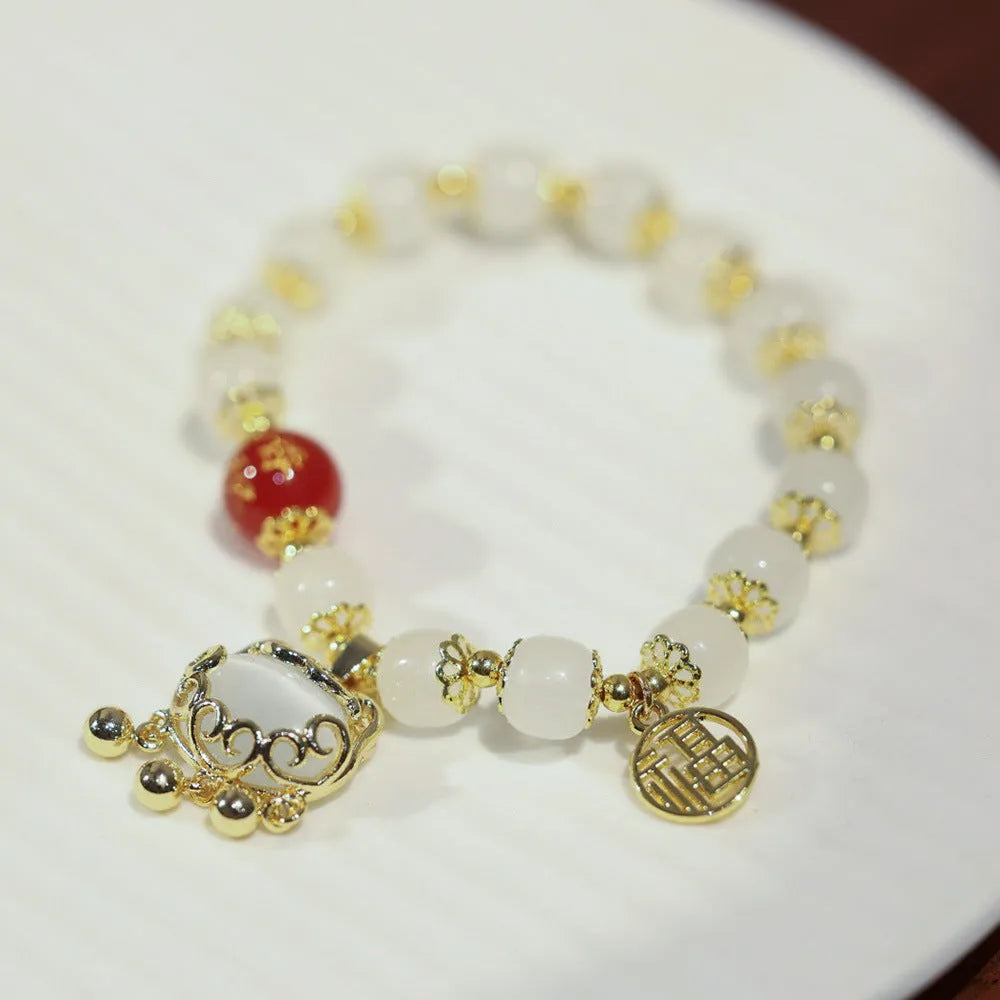 Chinese style women's coloured glass bracelet with safety lock and windmill charms