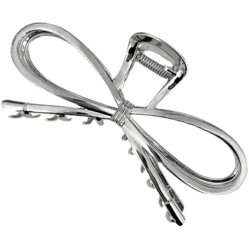 Women's bow hair barrette with back grip closure in gold or silver alloy