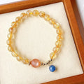 Women's gold rutilated quartz sunstone crystal bracelet with diamond-shaped beads