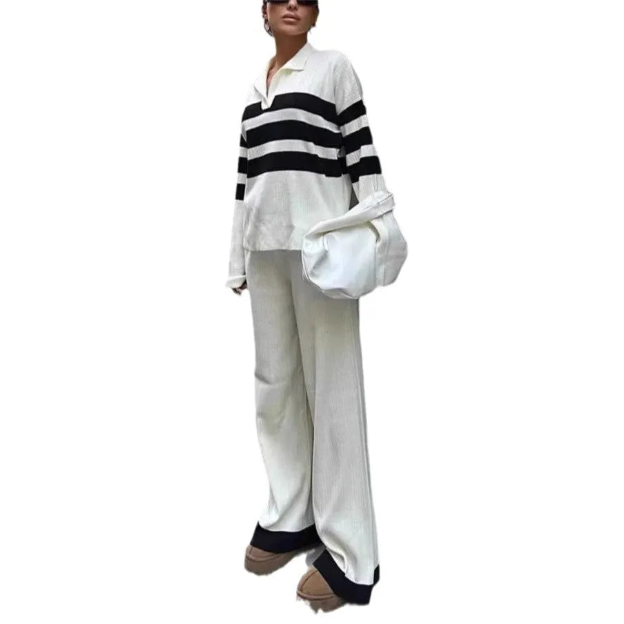 Women's black and white striped knitted two-piece set with a polo collar, featuring a long-sleeve top and trousers.