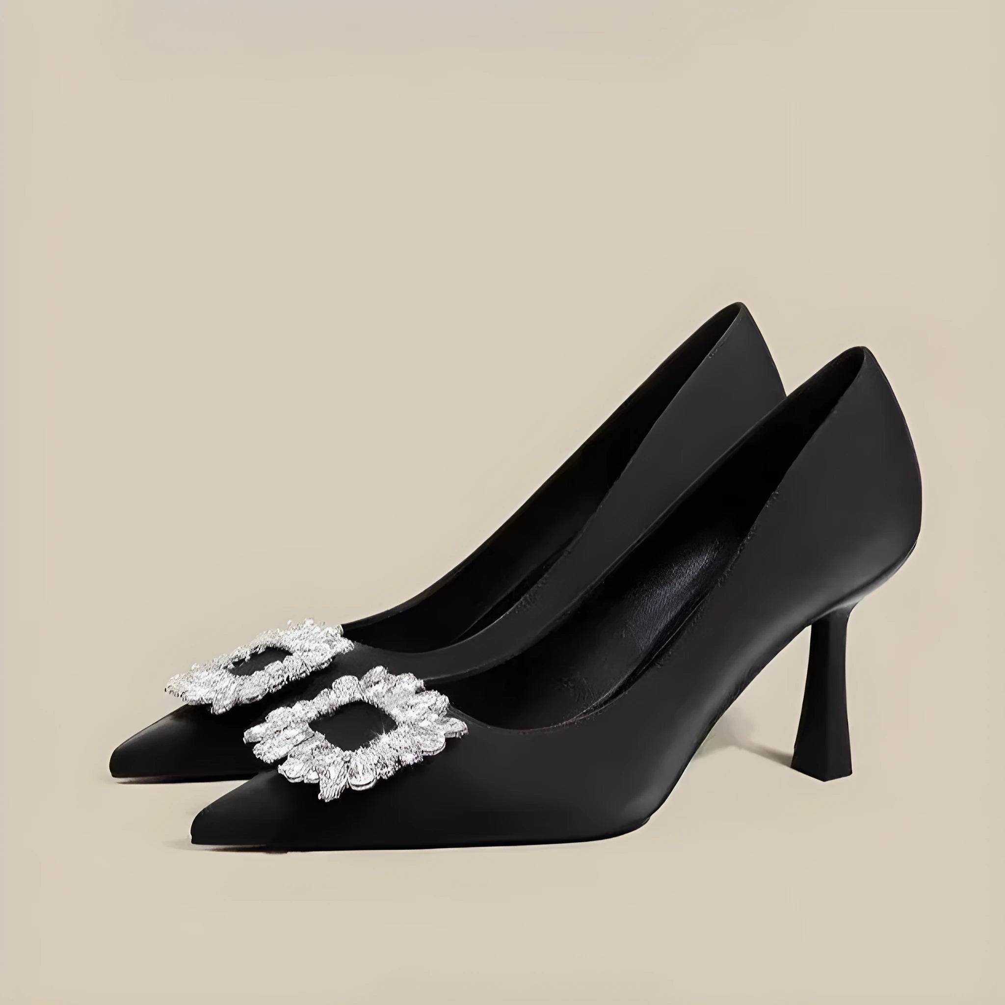 Women's creamy-white pointed toe stiletto pumps with a mid-height heel on a plain background.