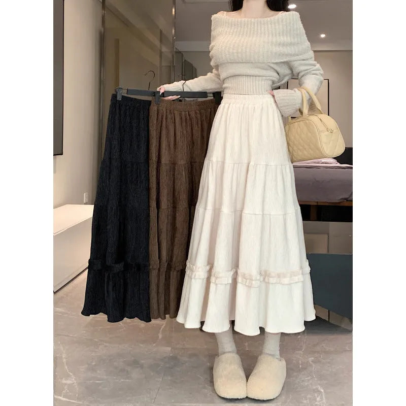 Women's beige corduroy A-line midi skirt with an elasticated waistband on a hanger.