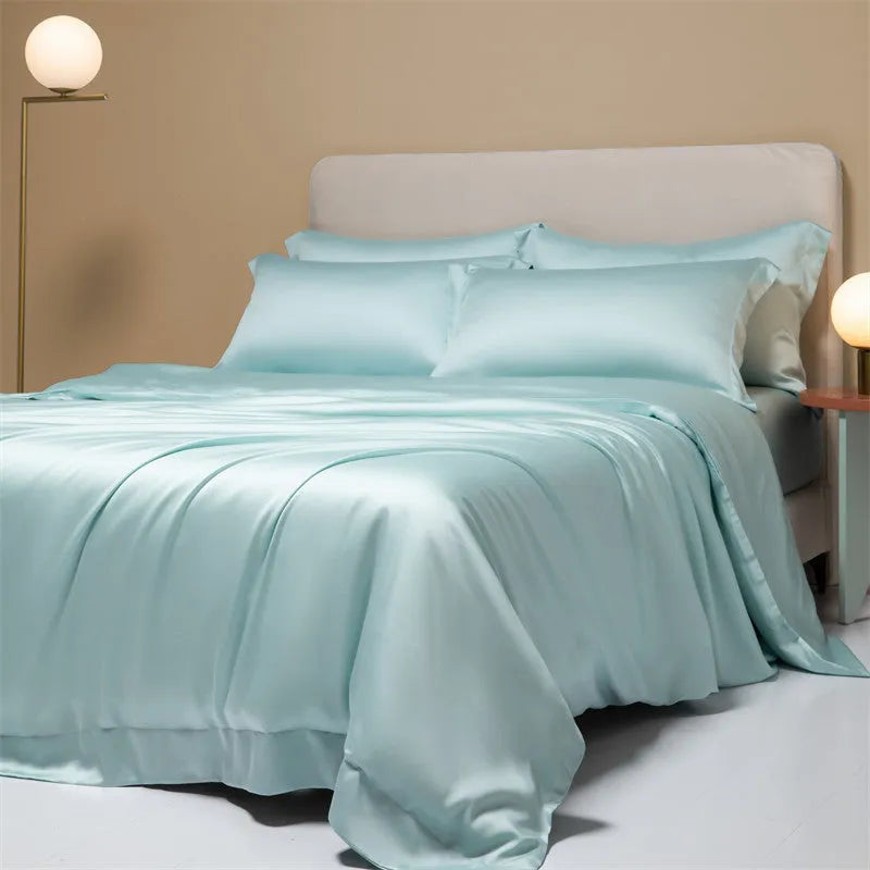 200 thread count Lenzing Tencel quilt cover and sheet set in Aurora Blue, laid on a bed.