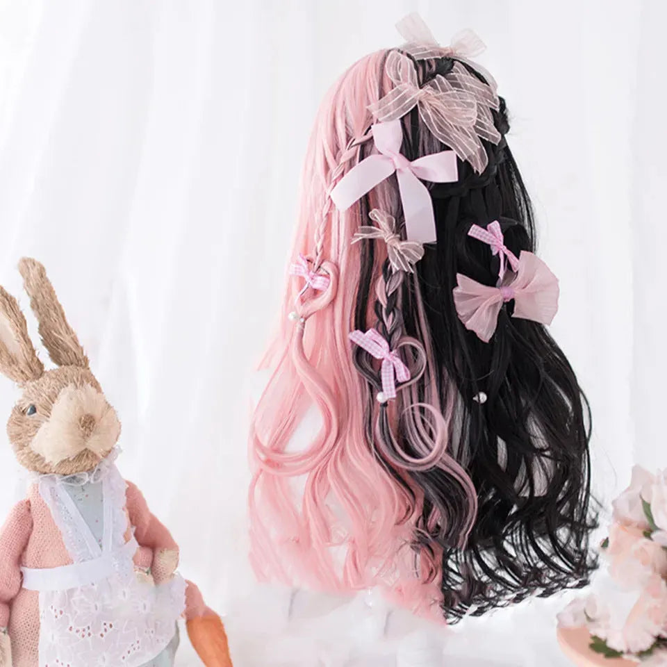 Harajuku Japanese Lolita style long curly black and pink wig with bangs on a wig stand.