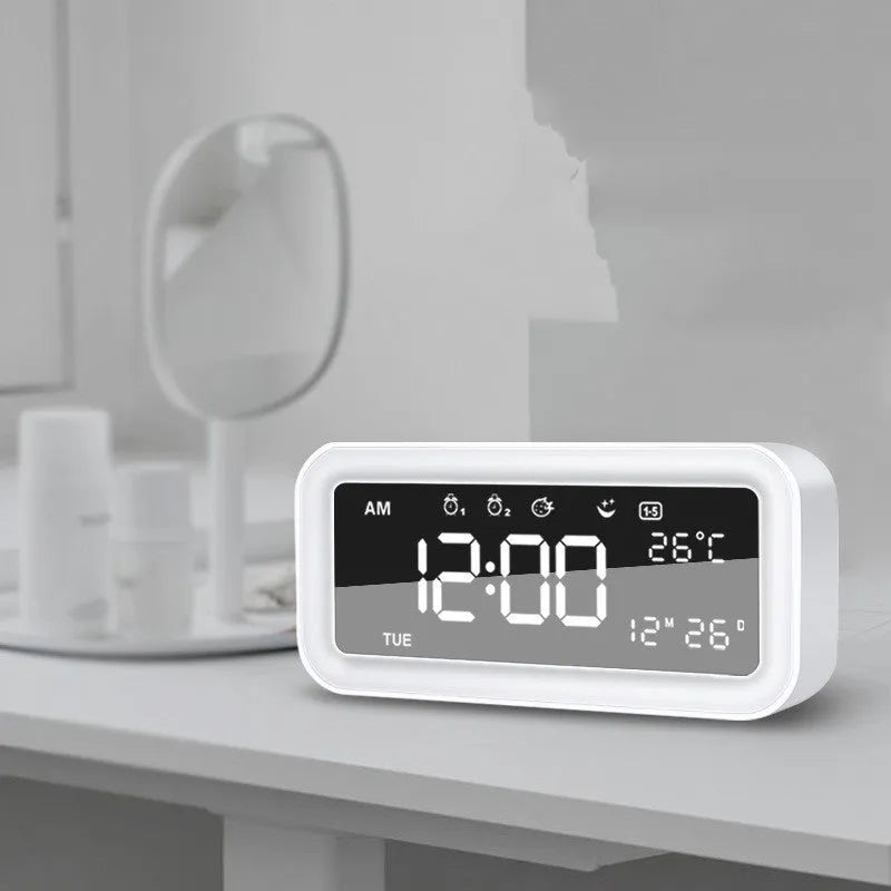 Blue rectangular LED digital alarm clock with multicoloured ambient light display.