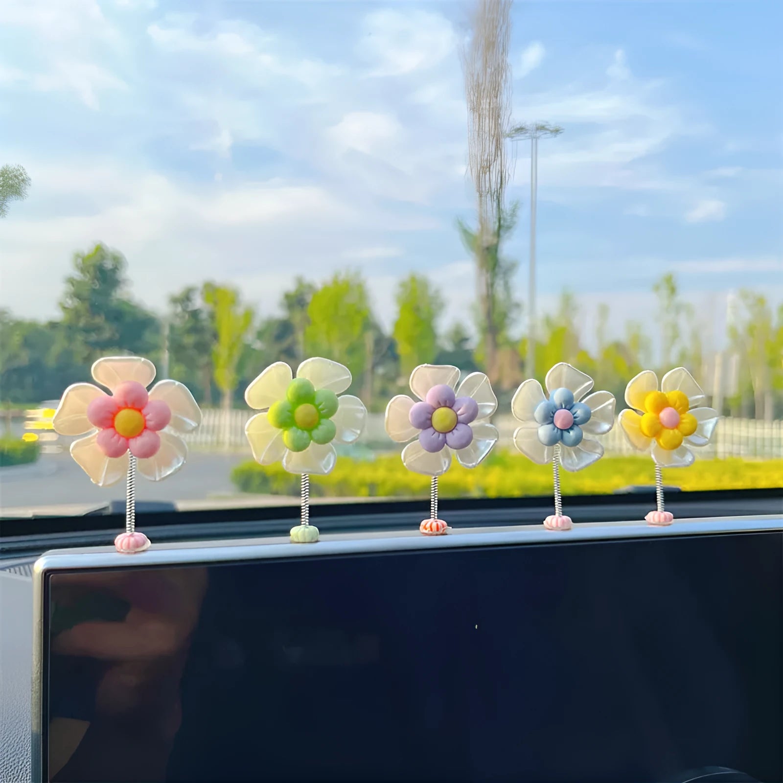Small plastic colourful swing car decoration shown in multiple colour options.