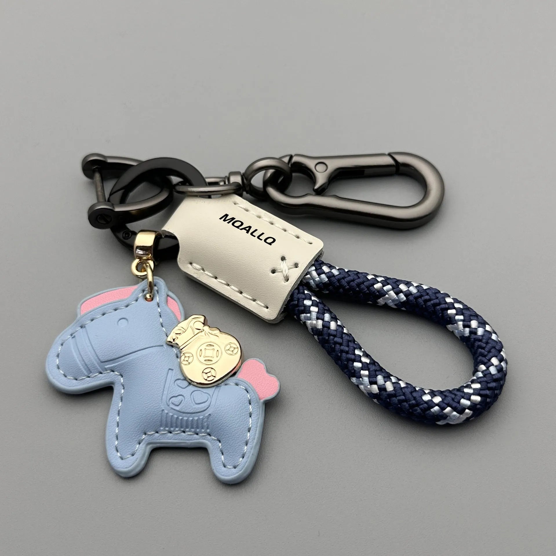 Handmade brown cowhide leather key ring pendant with a gold-toned zinc alloy pony belt buckle and green flanelle rope.