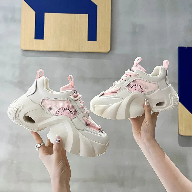 Women's pink sneakers with cross strap design and thick platform sole