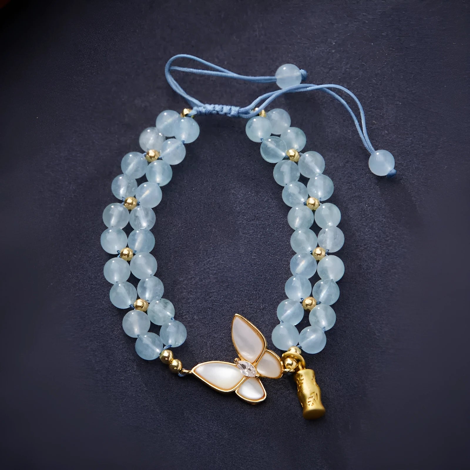 Women's aquamarine woven bracelet with butterfly design and 6mm stone beads