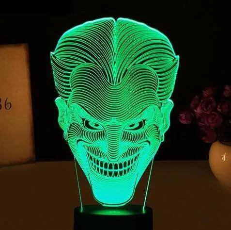 USB-powered 3D acrylic LED table lamp with remote control on a desk, displaying colourful gradient lighting.