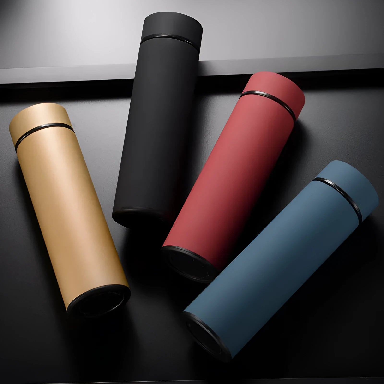450ml straight cup stainless steel water bottle with vacuum insulation and arrow mouth in black, red, gold, and blue colours.
